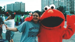 Jennifer (right) with Elmo at a community outreach event.